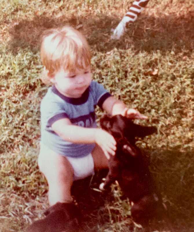 Picture of Dr. Kerr as a toddler with little dog